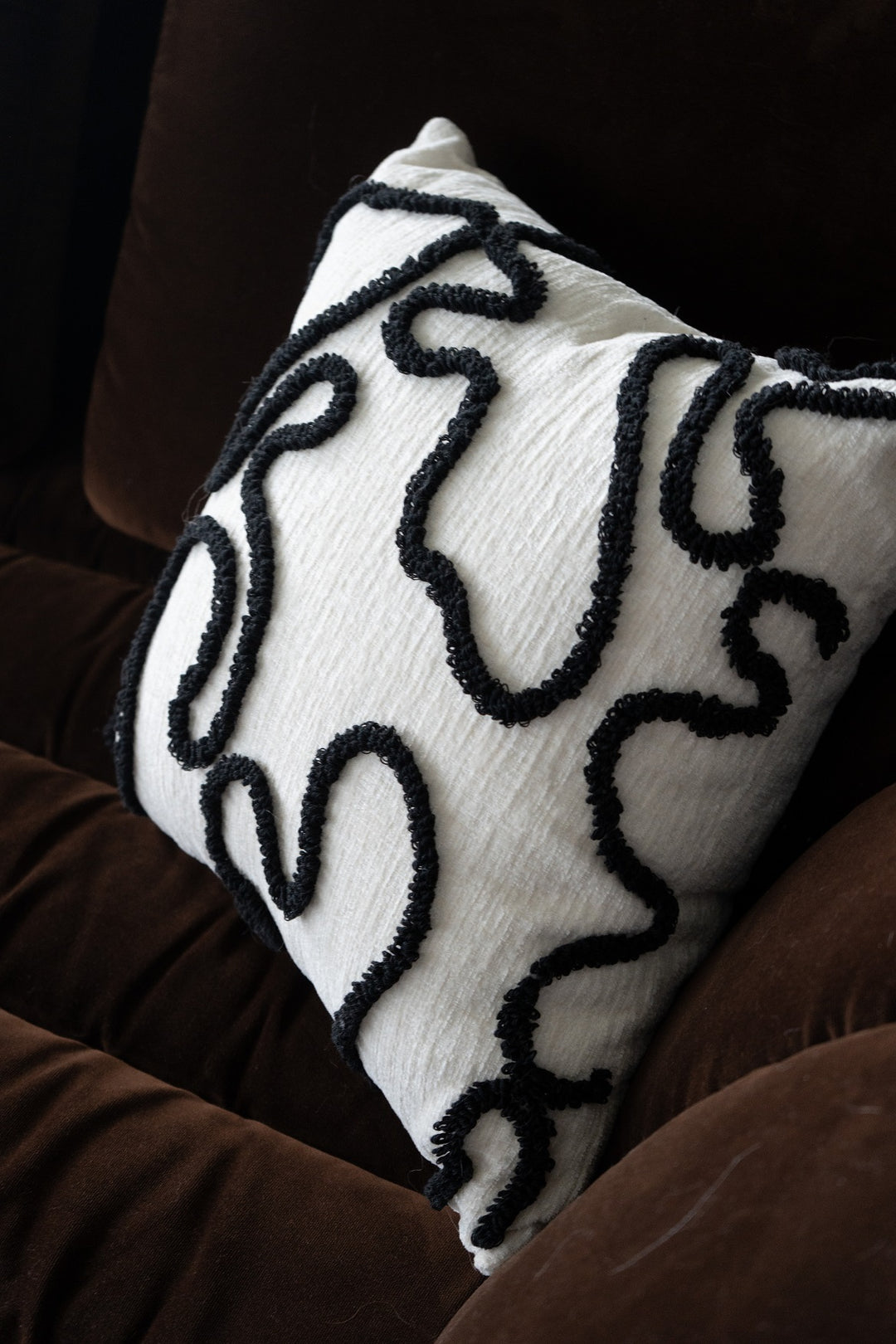 Chenille pillow with black embroidery