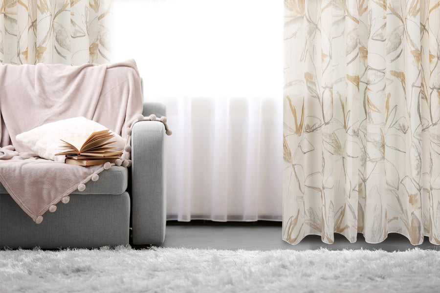 Athena printed abstract floral sheer grommet curtain in beige, styled at a window