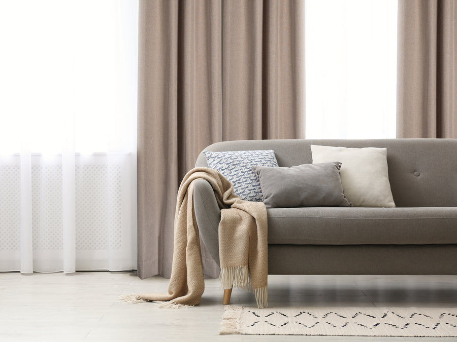 Berlin textured blackout grommet curtain in beige, styled at a window