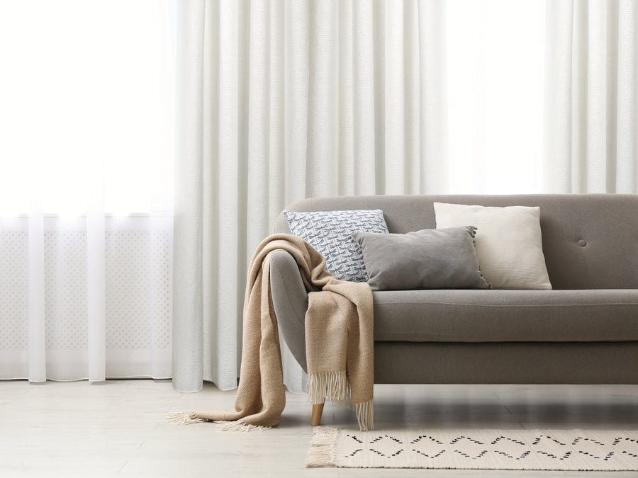 Chieti light filtering white jacquard curtain, styled at a window