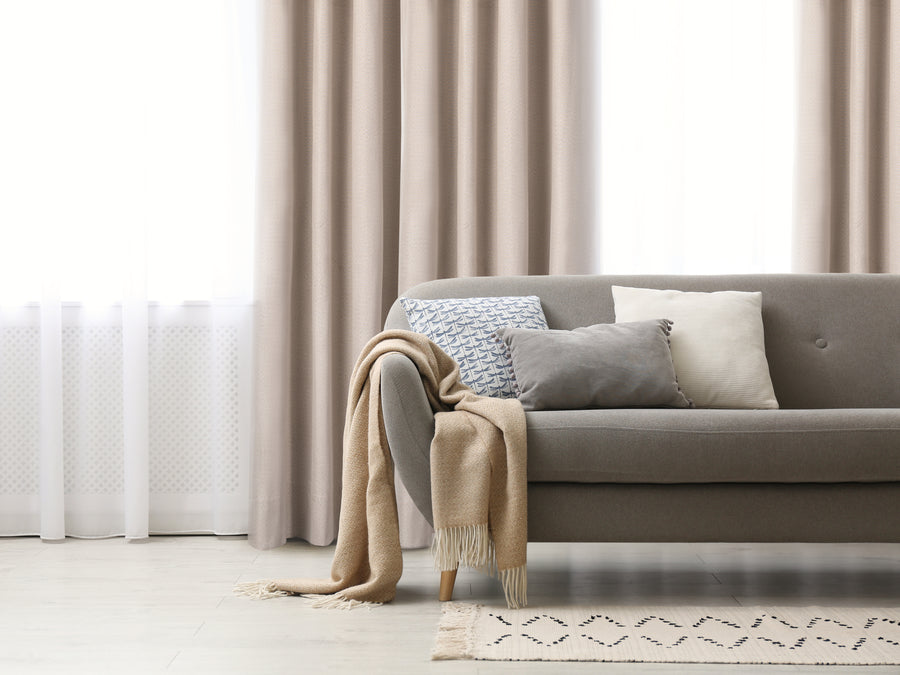 Copa textured blackout grommet curtain in beige, styled at a window
