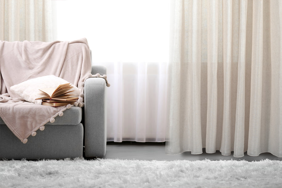 Gusto jacquard sheer grommet curtain in linen, styled at a window