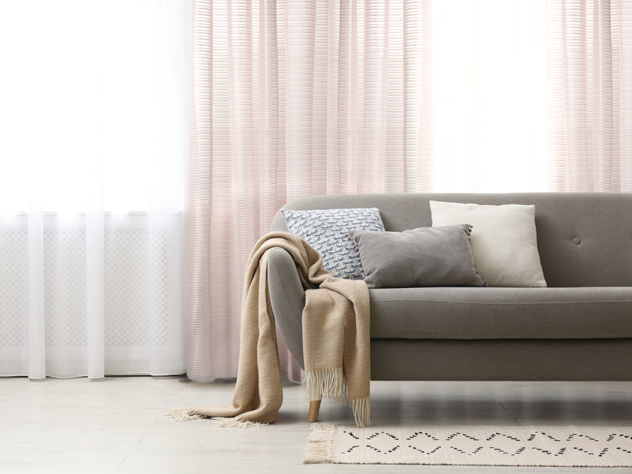 Imola striped jacquard sheer grommet curtain in blush, styled at a window