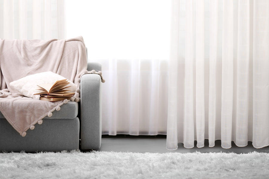Kozani jacquard plaid sheer grommet curtain in white, styled at a window