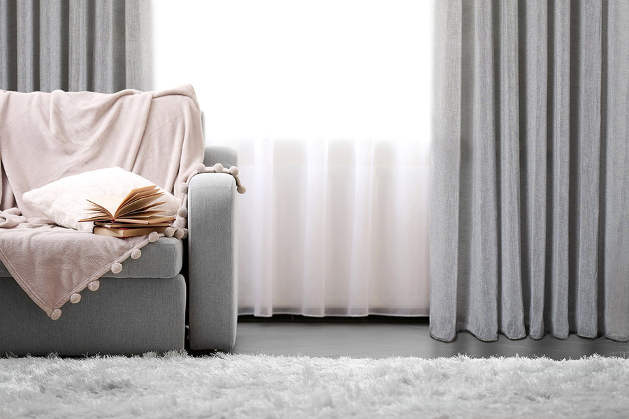 Marbella textured linen look sheer grommet curtain in grey, styled at a window