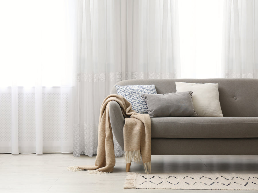 Massa classic embroidered sheer grommet curtain in natural, styled at a window