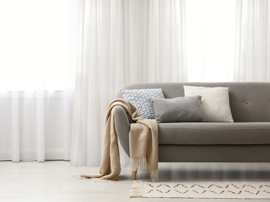 Olympia semi sheer diamond pattern grommet curtain in natural, styled at a window