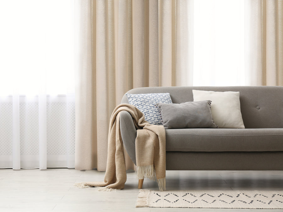 Ortona boucle style heavy semi sheer grommet curtain in natural, styled at a window