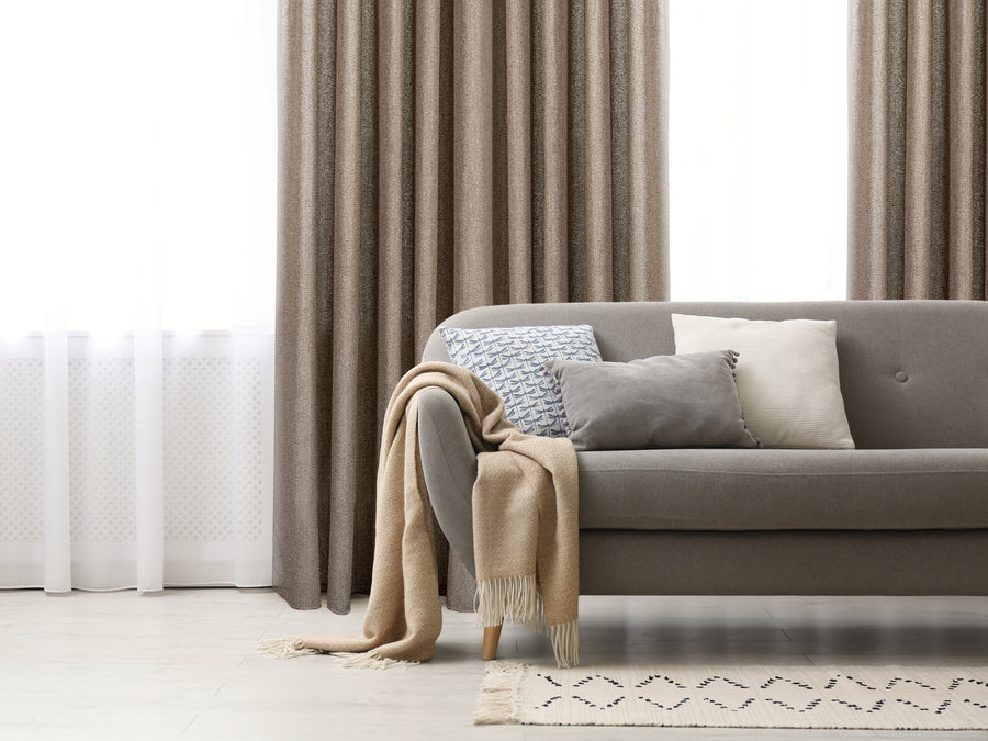Pisa heavy semi sheer jacquard grommet curtain in mocha, styled at a window