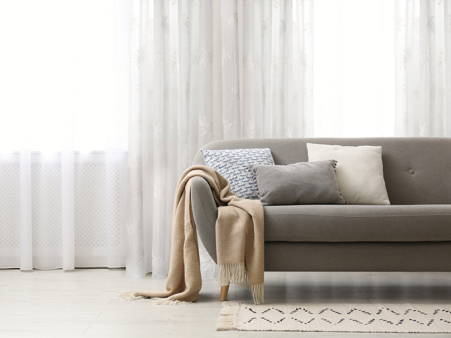 San Tropez embroidered floral sheer grommet curtain in natural, styled at a window