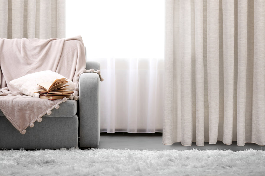 Zante heavy textured semi sheer wide width curtain in greige, styled at a window