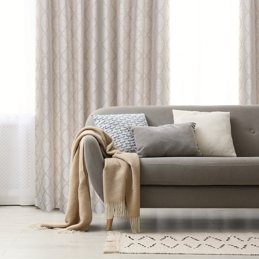 Zurrich textured jacquard curtain in beige, styled at a window
