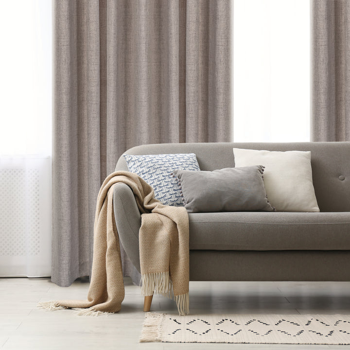 Levanto light filtering linen look jacquard curtain in stone, styled at a window
